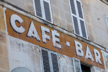 Obraz premium vintage bar cafe paint sign text on wall coffee ancient in city street storefront building entrance
