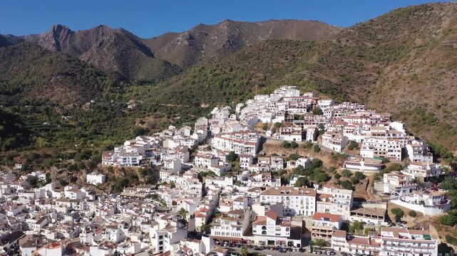 Drone view of the small town with white houses and surrounding countryside, Ojen, Spain in the summer