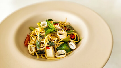 Stir fried spaghetti with dried chili and sausage, black pepper and basil. Stir Fried Spicy Spaghetti with sausage. Spicy spaghetti with mixed sausage and herb.