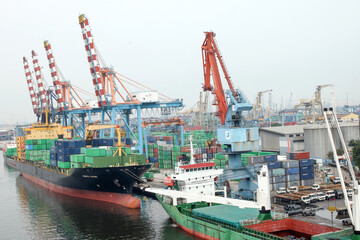 Fototapeta premium Container Ship Docked In The Port For Loading And Unloading Containers