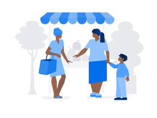 Two women at the market choose fruit
