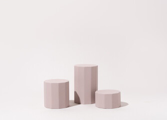 Cosmetics product presentation mockup scene made with three beige pillars podium stage in sunlight....