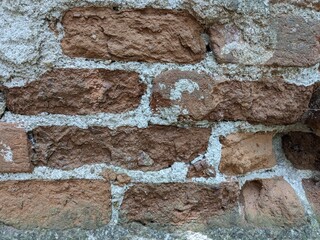 patterns of red bricks of and old abandoned church tower wall.Medieval gothic church reamins in central Europe