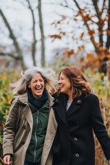 Two middle-aged women laughing and walking in the park
