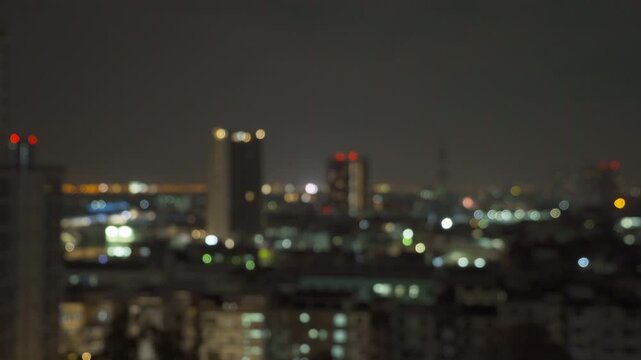 Bokeh abstract background of skyscraper buildings in Bangkok city, Thailand with lights, Blurry photo at night time. Cityscape.