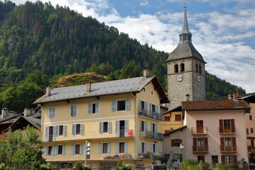 The village Beaufort, Beaufortain, Savoie, France, with colorful buildings and the church Sainte...