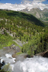 The Rutor waterfalls overlooking the valley towards La Thuile in Italy, Aosta Valley, with high peaks in the background 
