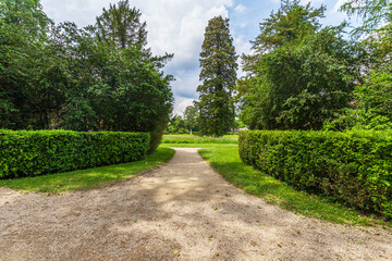 Peaceful Pathway through Lush Gardens at Chateau de Fontainebleau