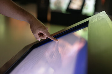 finger on large touch screen.  Interactive screens for teaching, education, receiving the information