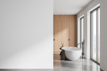 Wooden hotel bathroom interior with bathtub and panoramic window, mockup wall