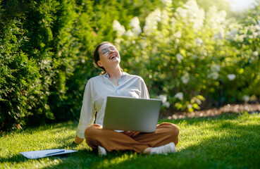 woman working on laptop in summer morning