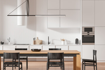 White home kitchen interior with dining table and cooking space, closeup