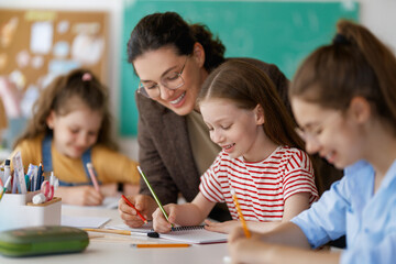 Happy kids and teacher at school