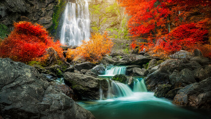 Amazing in nature, beautiful waterfall at colorful autumn forest in fall season	