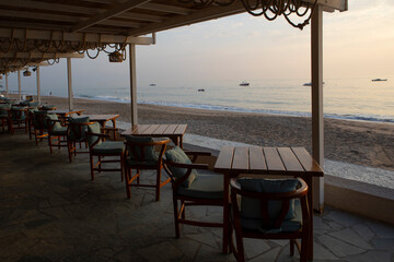 Outdoor cafe on the beach. Cafe at dawn by the sea or ocean. Without people. The concept of recreation.