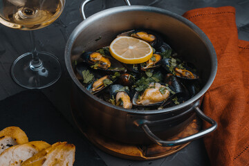 Mussels cooked according to a traditional Italian recipe in a sauce of white wine, garlic, lemon juice, shallots, butter and chopped parsley. Seasoned with salt and pepper.