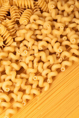 Food background of dry pasta close-up, top view