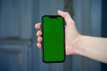 Smartphone with green screen.
Chrome key on the phone.
Blank screen to replace background