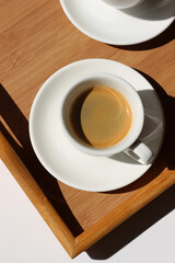 Coffee in Bed. Two Cups of Espresso on Wooden Tray. 