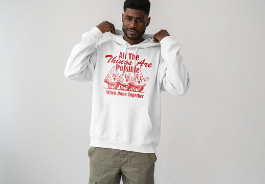 Mockup Of Man In Customized Hoodie In Studio Putting Hood Up