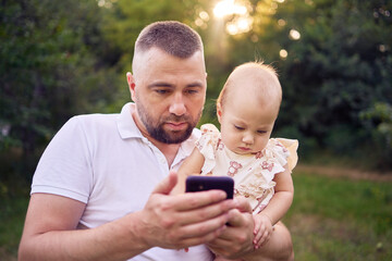 dad playing with his baby daughter in the garden