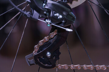 Fototapeta premium Mountain bike repair and maintenance. The rear derailleur is a close-up on a black background.