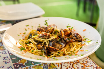 Italian Pasta with seafood Spaghetti with clams and bottarga, clams or vongole and parsley. Sicilian restaurant.