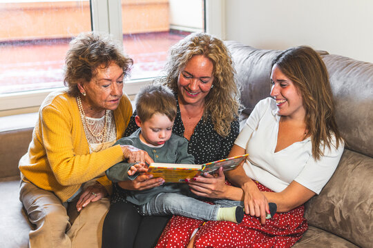 Family reading book with boy at home