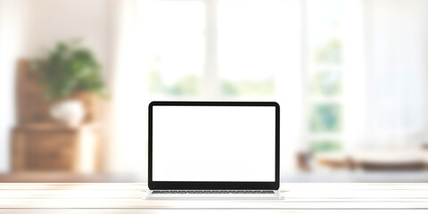 A laptop with a blank screen sits on desk blur background.