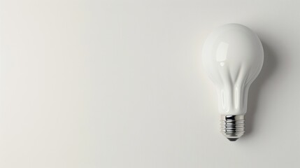 A minimalist composition featuring a single white lightbulb against a clean white background, with ample copy space around it. This simple yet impactful image is perfect for conveying ideas related