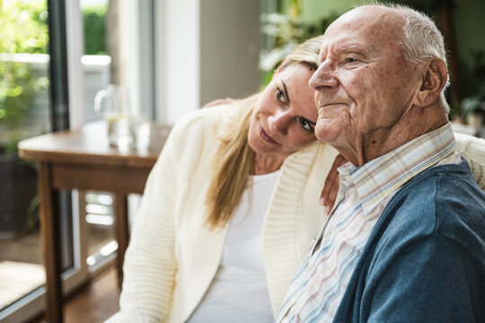 Blond woman spending time with father at home