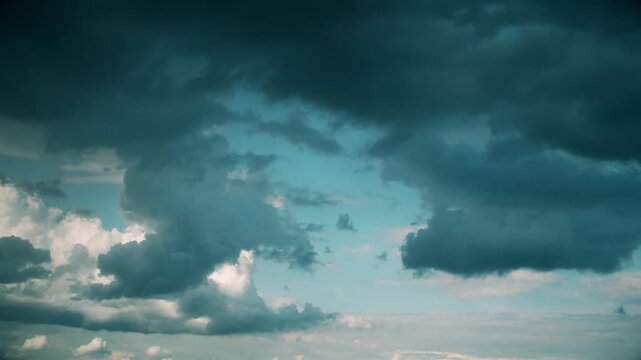 Dark dramatic clouds before a storm. A sky where rain is gradually gathering. The anticipation of a motionless thunderstorm. An abstract background on the theme of bad news.