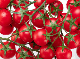 Lot of ripe red cherry tomatoes isolated on white background.