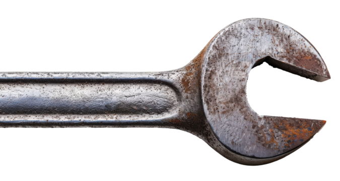 Close-up of a well-worn, semi-rusty open-ended wrench against a white background, showcasing texture and marking details.
