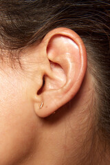 Close-up of female ear without jewels. Taking care after health, visiting doctors, check up. Concept of female beauty, skin care, cosmetology and cosmetics, healthcare.