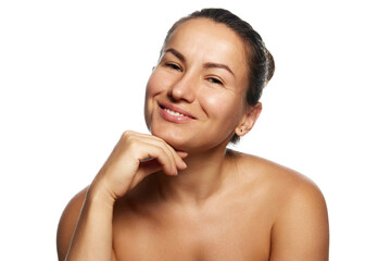 Charming, smiling woman with well-groomed skin leaned on her hand and looking at camera against white studio background. Appearance and confidence. Concept of facial care, lifting, surgery.