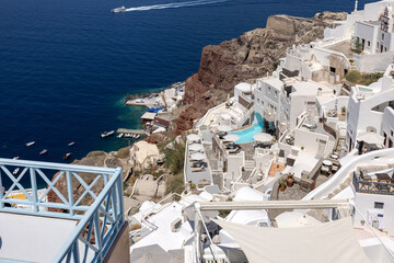 Whitewashed houses with terraces and pools and a beautiful view in Oia on Santorini island, Greece