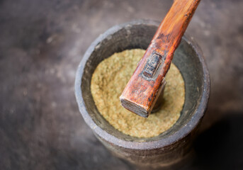 hard wood grinder hitting Rice in vitage equipment