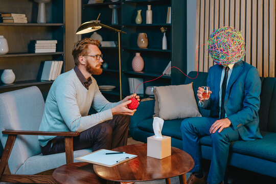 Psychotherapist unwinding thoughts of frustrated patient sitting on sofa