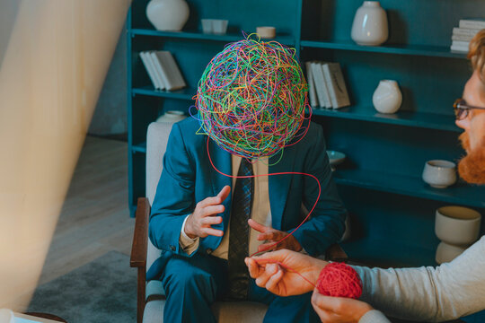 Psychotherapist with patient explaining problems wearing chaotic mask