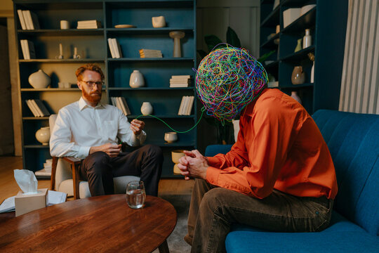 Patient with hands clasped taking advice from psychotherapist