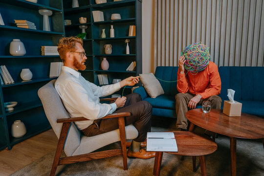 Psychotherapist siting on chair and treating depressed patient