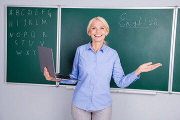 Photo of professor charming intelligent senior woman teacher conduct lesson for students in...
