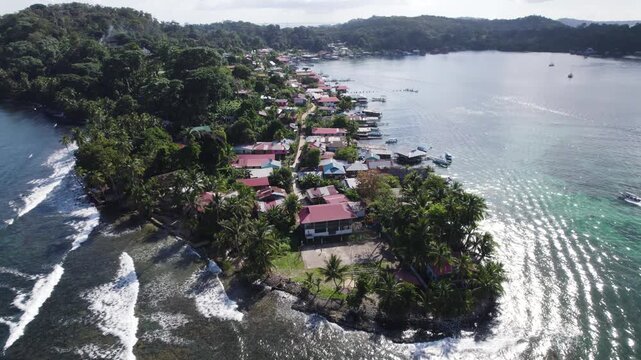 Aerial view of Bastimentos Island, located in Bocas del Toro District, Panama, showcasing a picturesque village by the coast. circle dolly