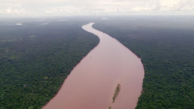 Aerial: Fresh water river going through thick amazon jungle, Suriname