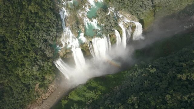 Panoramic high angle overview of Tamul Waterfall with cascading water from strong wide river emptying into canyon
