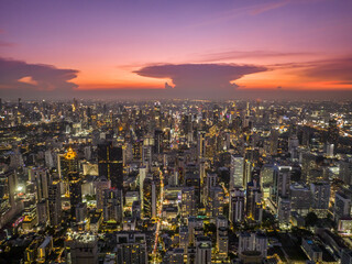 Aerial view Bangkok City skyline and skyscraper on Sathorn Road business and financial in Bangkok downtown. Bangkok cityscape in sunset time, Thailand. 