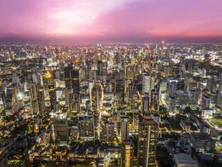 Obraz premium Aerial view Bangkok City skyline and skyscraper on Sathorn Road business and financial in Bangkok downtown. Bangkok cityscape in sunset time, Thailand. 