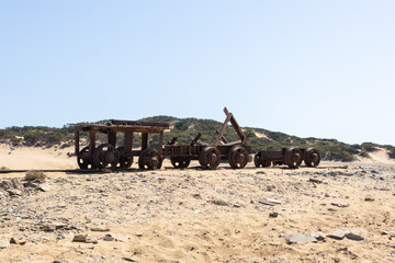 Rusted Mining Relics on Coastal Sand