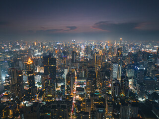 City street jam, cars in rush traffic on urban highway. Road traffic in city. Aerial view of road interchange or highway intersection with busy urban traffic. Bangkok